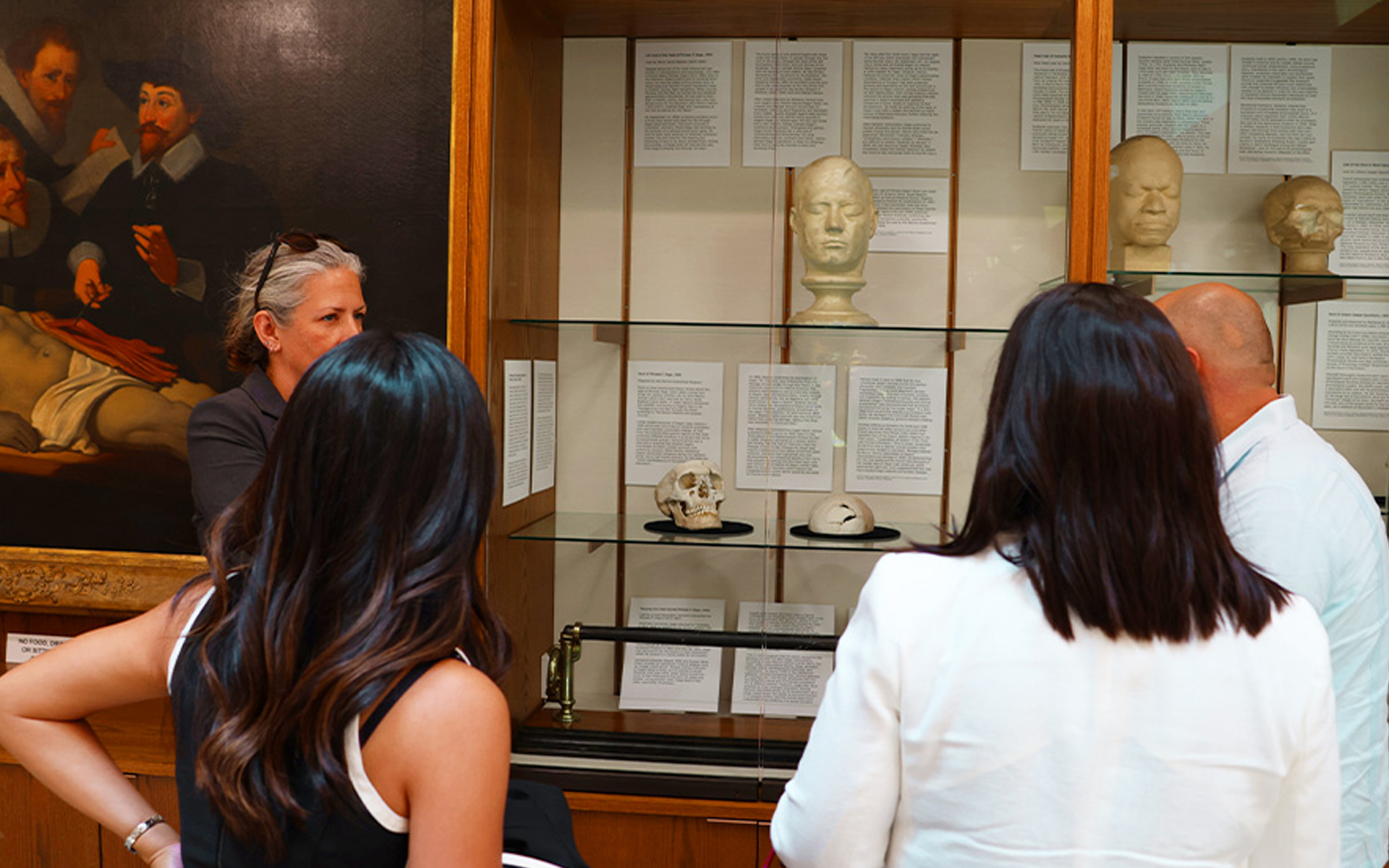 Photo of people looking at a glass case exhibition